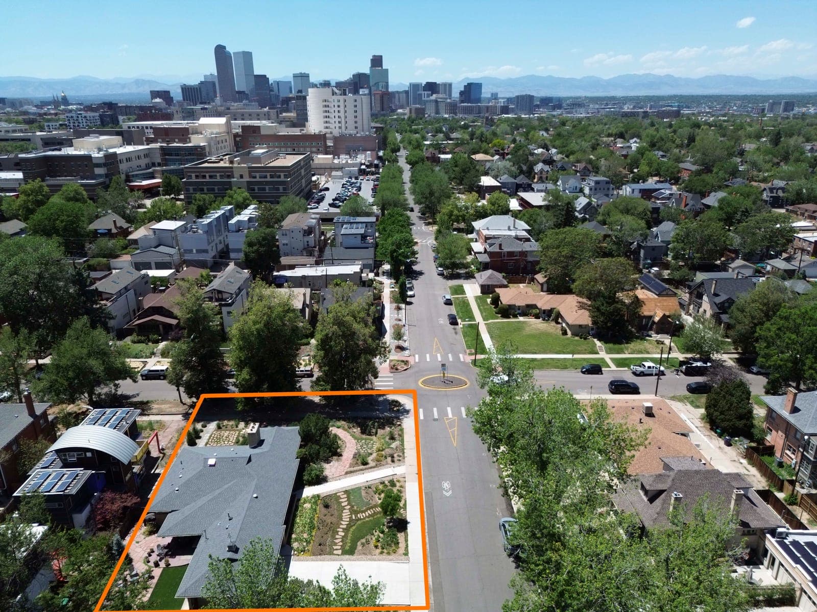 Aerial view with the property outlined and the downtown Denver skyline beyond