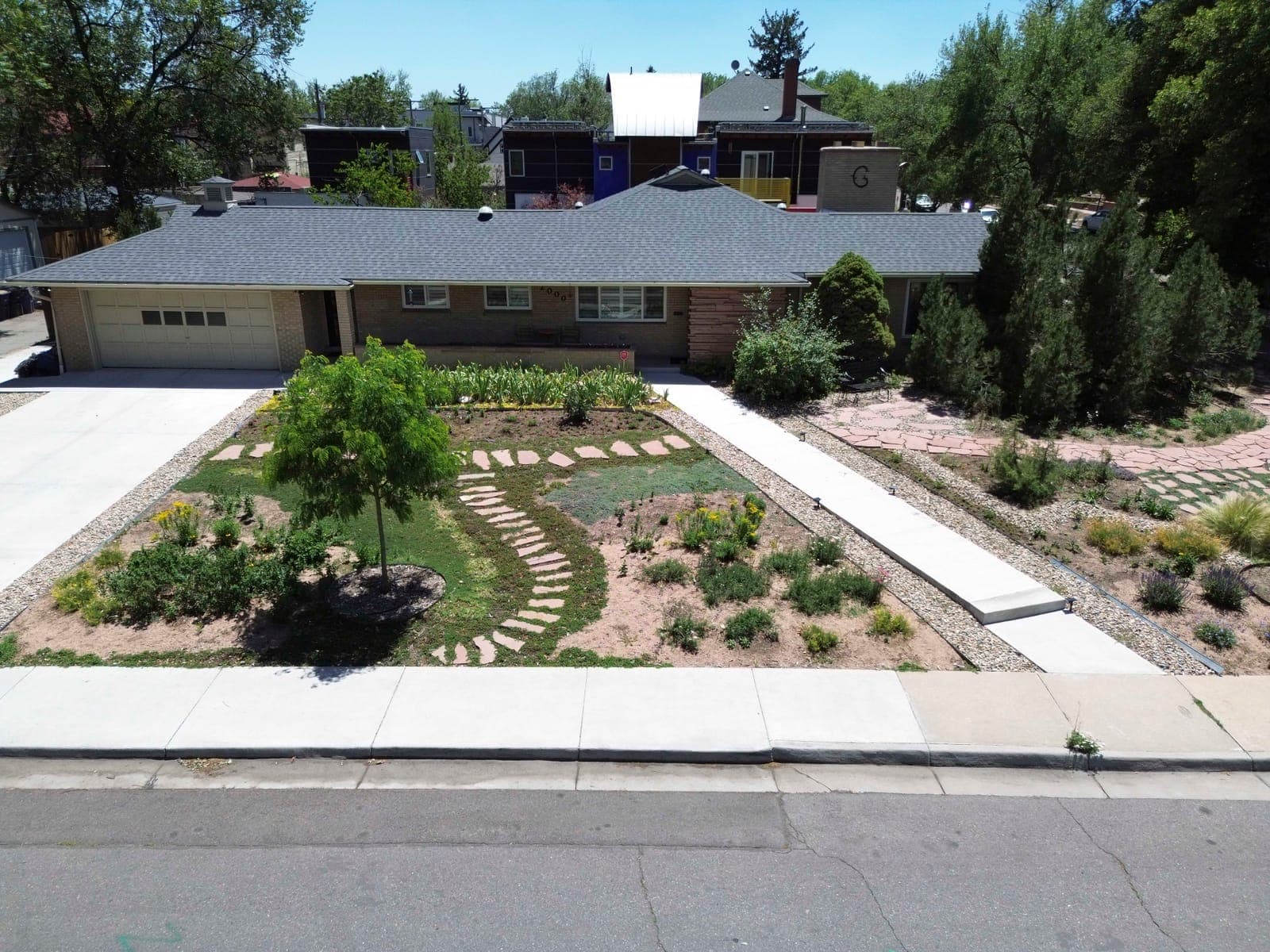 Front elevation from above showing the hipped roofline and flagstone garden paths