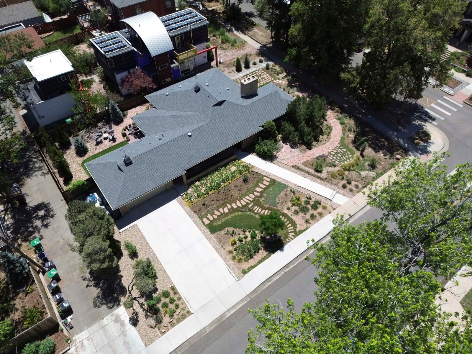 Aerial view over the property with the rear patio, turf panel, and layered plantings
