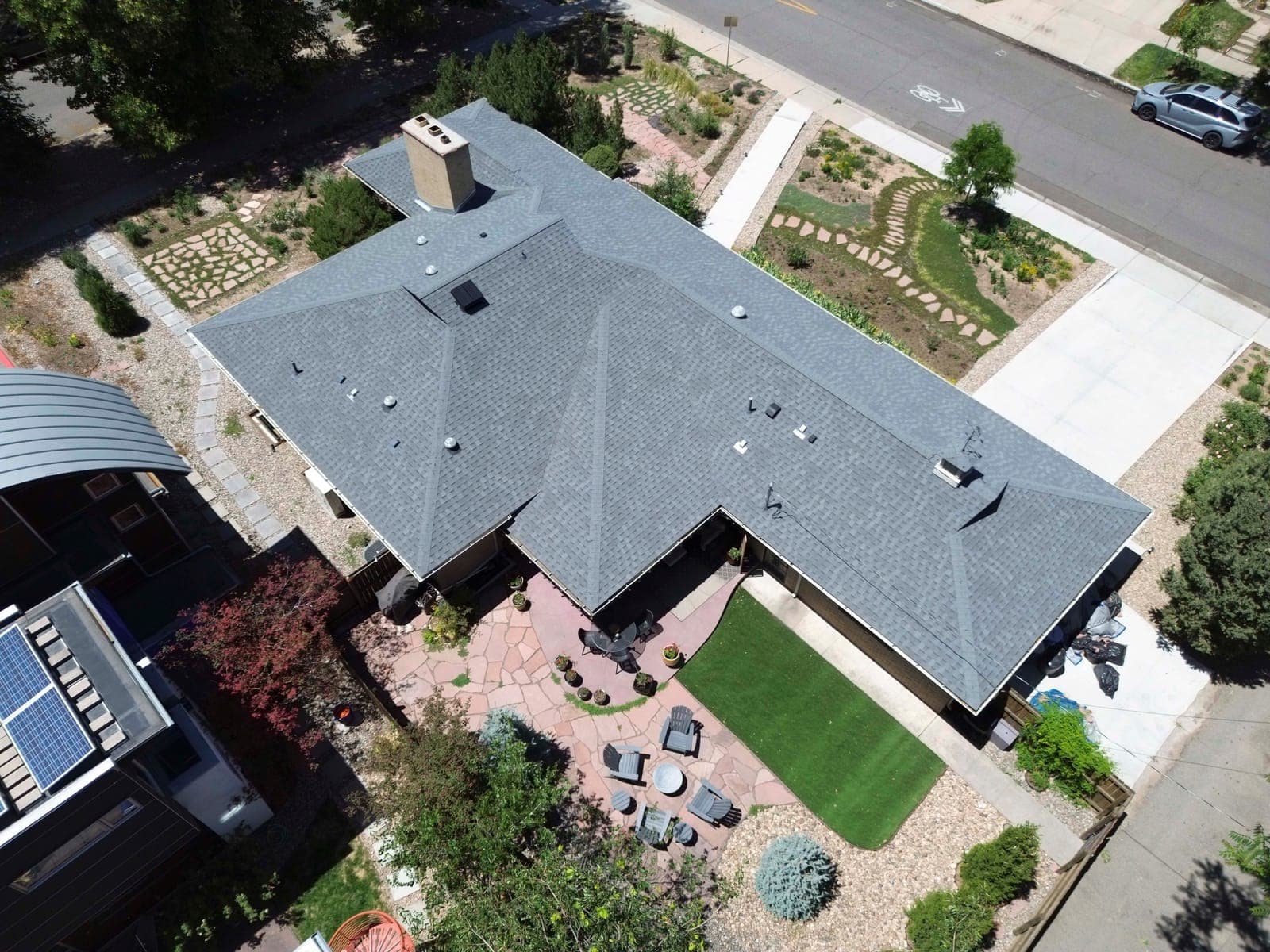 Overhead view of the roofline with the rear patio seating areas and gardens
