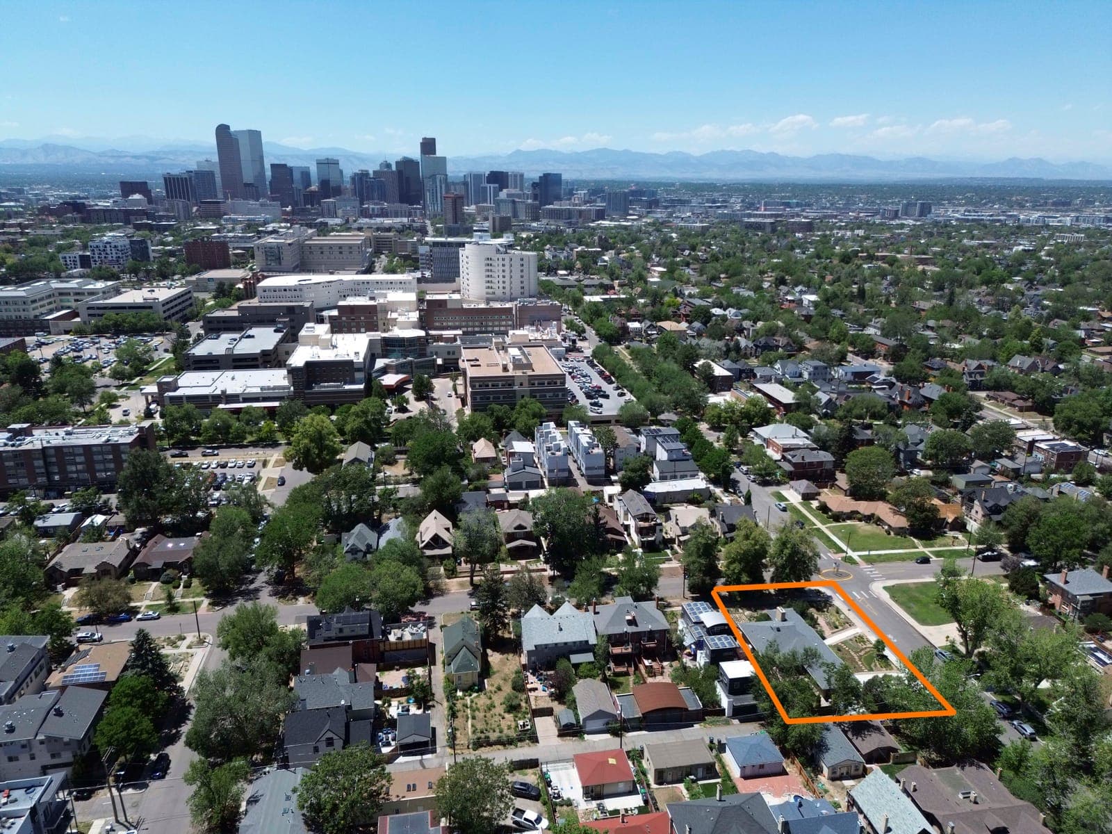 Elevated view of the outlined corner property looking toward downtown Denver