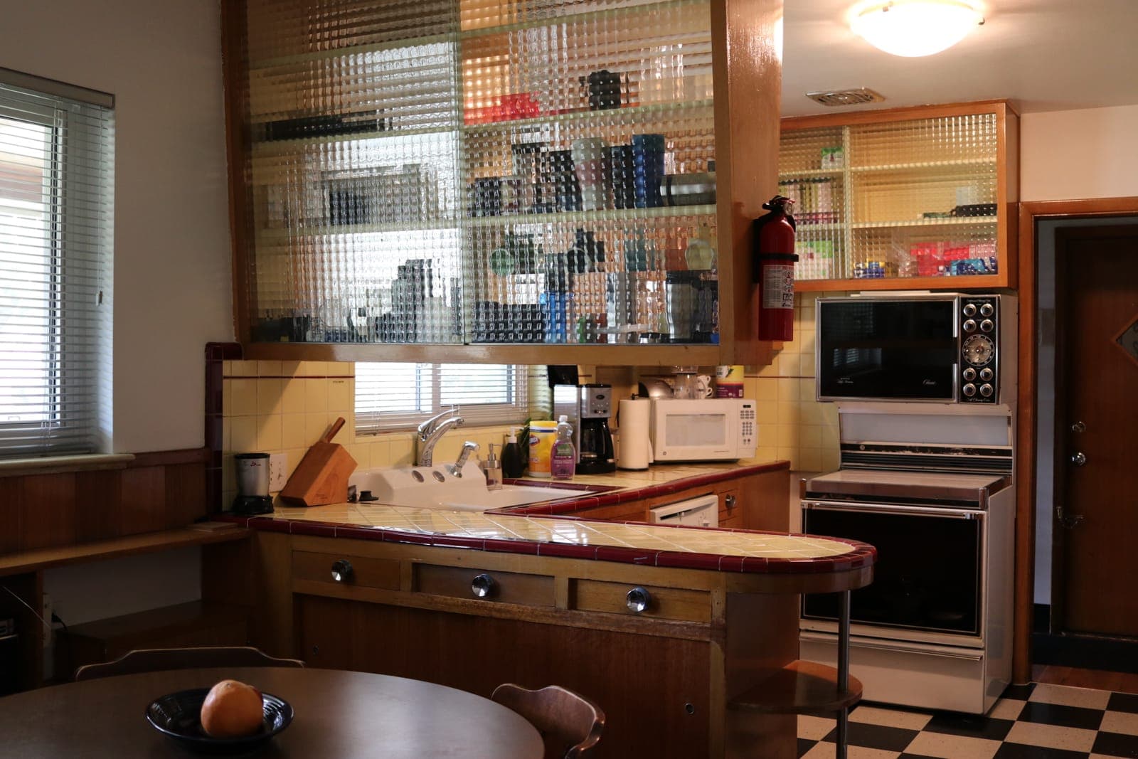 Original kitchen with built-in range, wall oven, and checkerboard floor