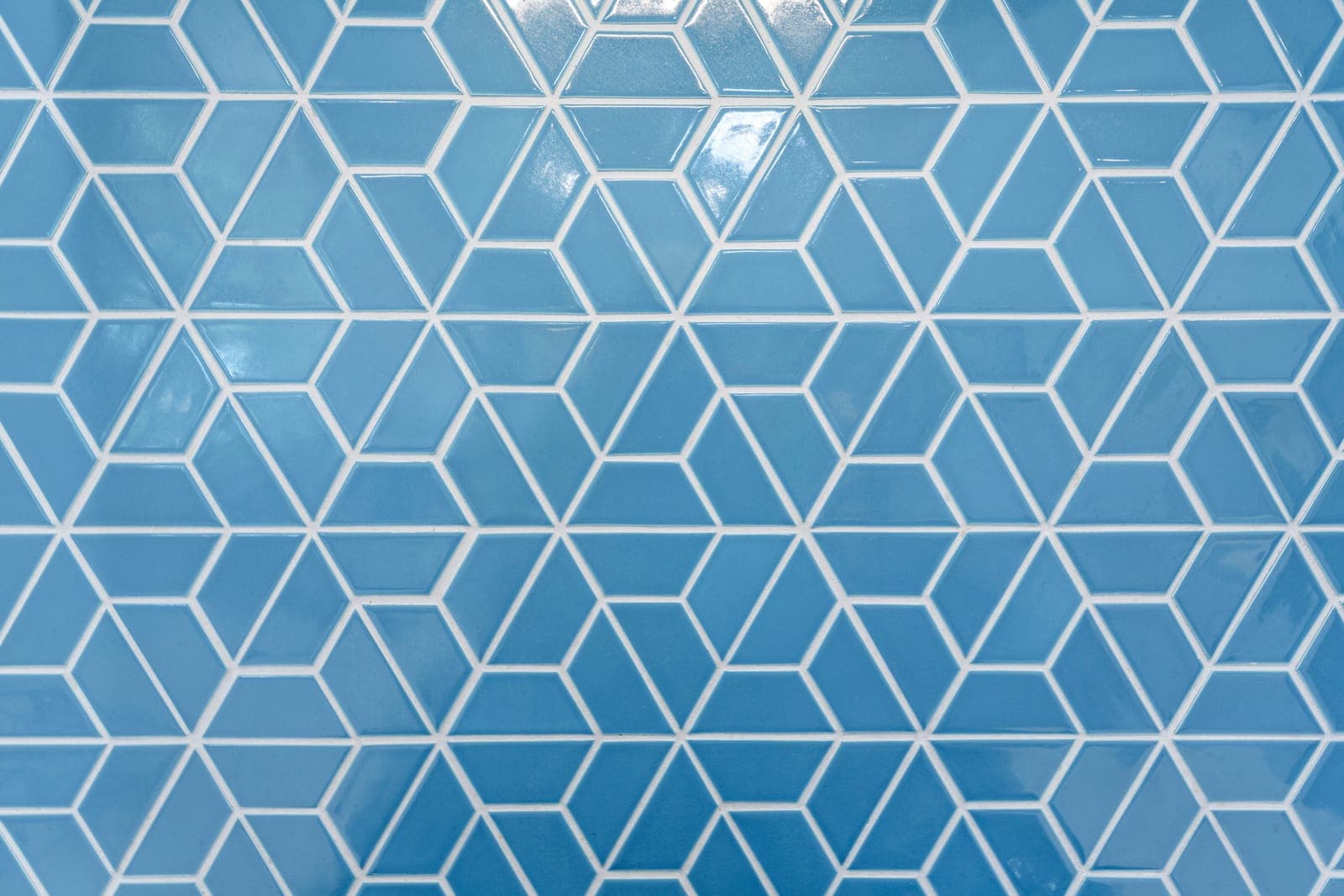 Close view of the blue geometric mosaic tile and its interlocking cube pattern