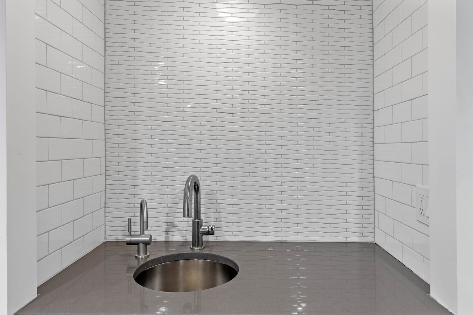 Wet bar sink with a round stainless basin, gooseneck faucet, and filtered-water tap