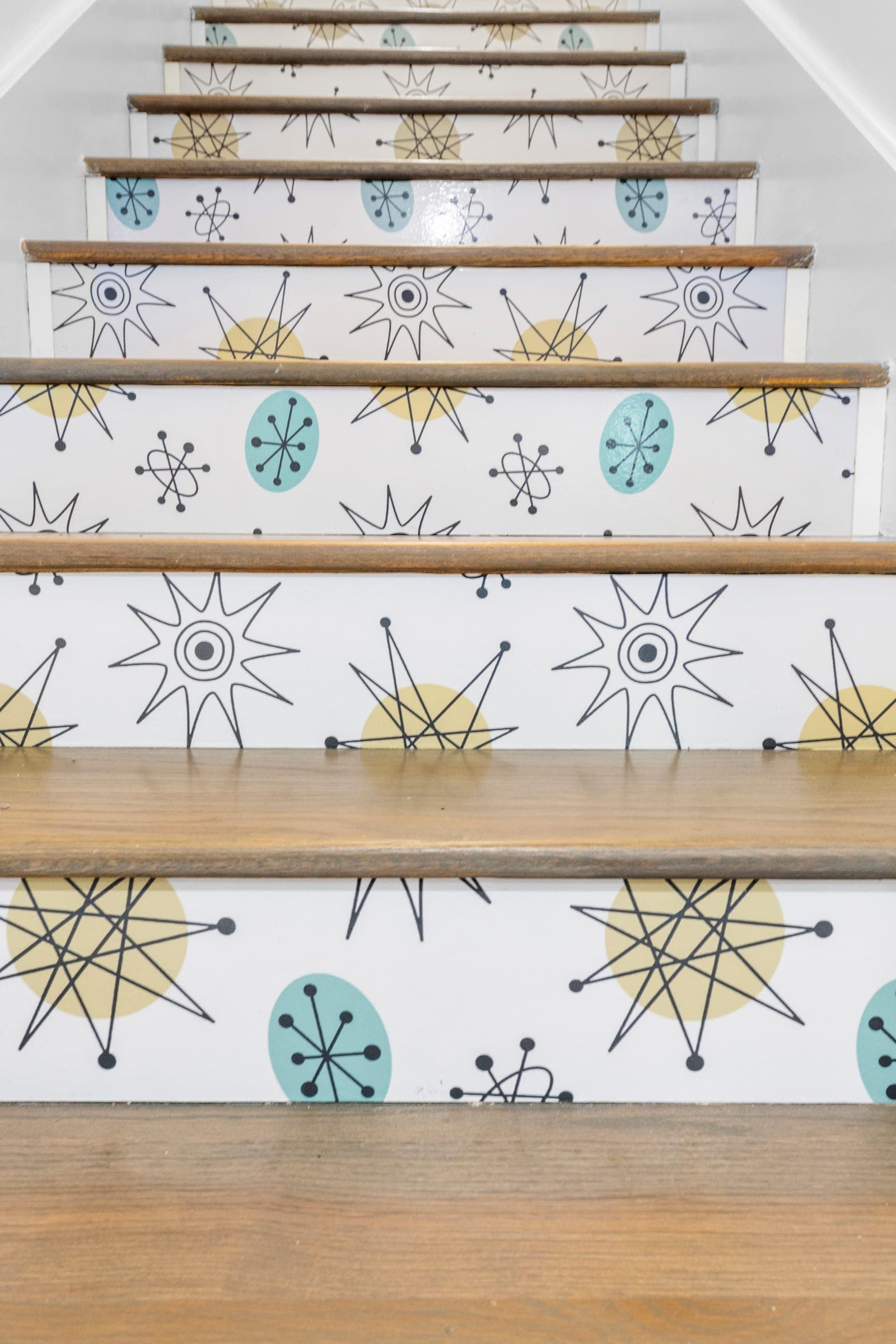 Staircase with wood treads and atomic starburst patterned risers