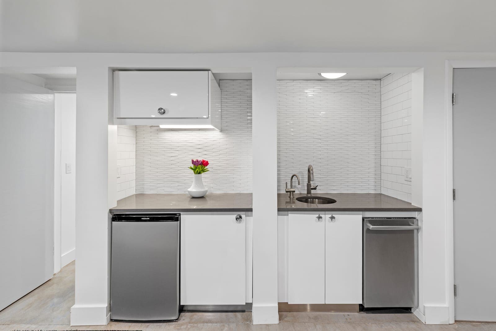 Wet bar with white cabinetry, grey quartz counters, a compact refrigerator, and dishwasher